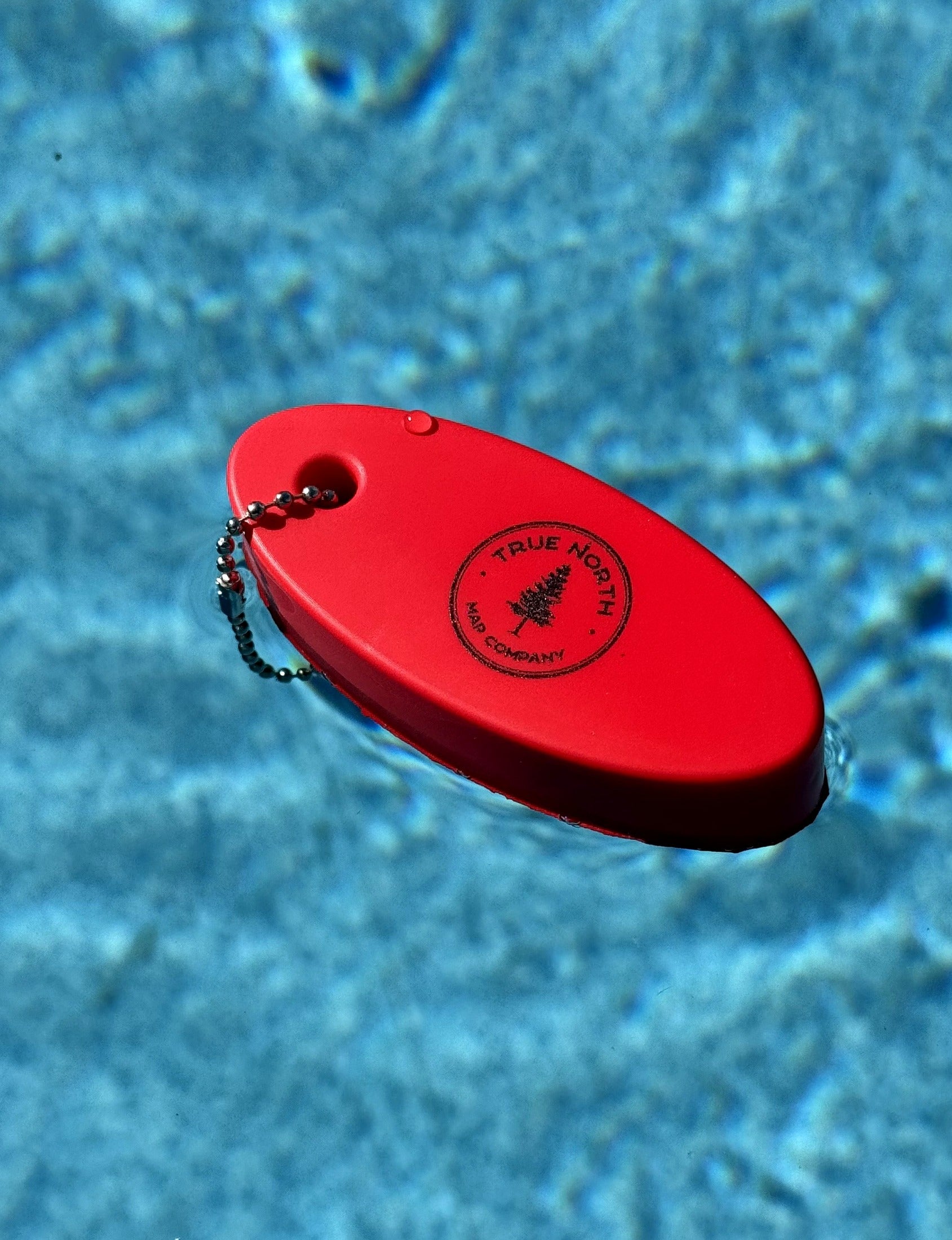 True North Map Co. floating keychain floating in water