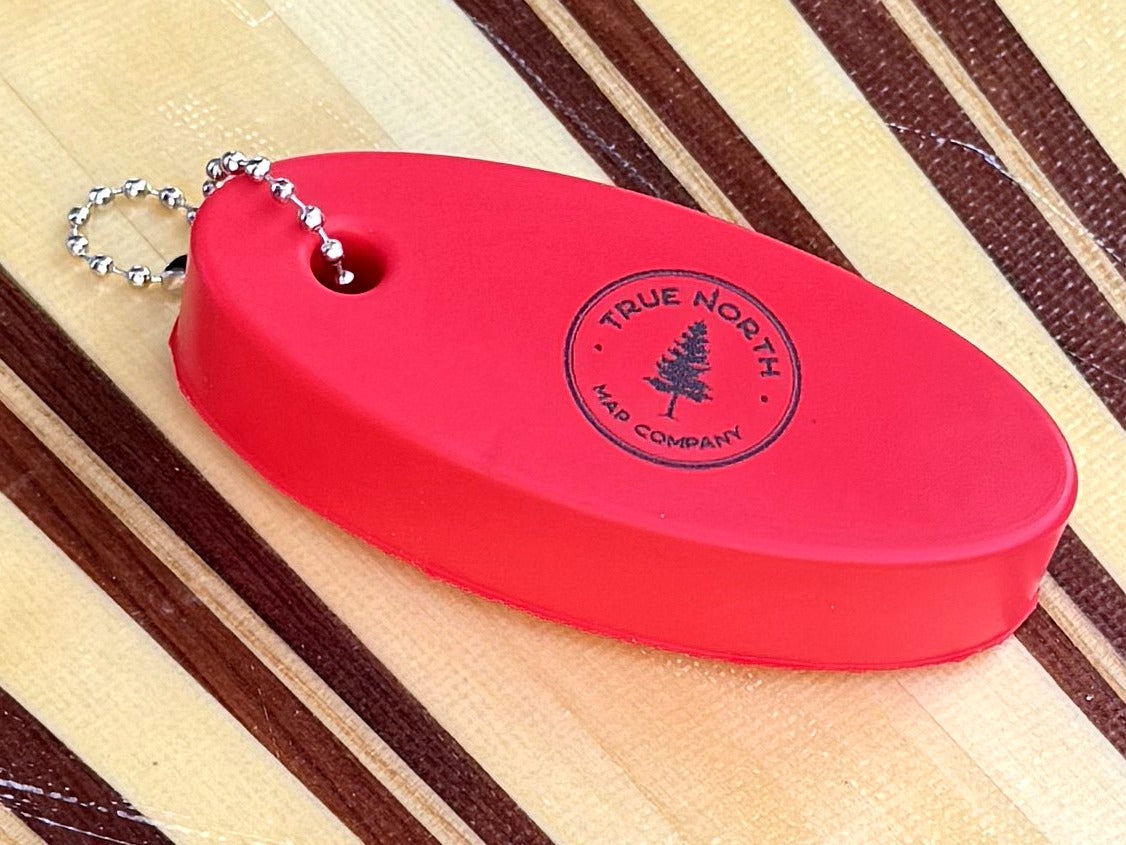 Detail of the True North Map Co. logo stamped on the floating keychain